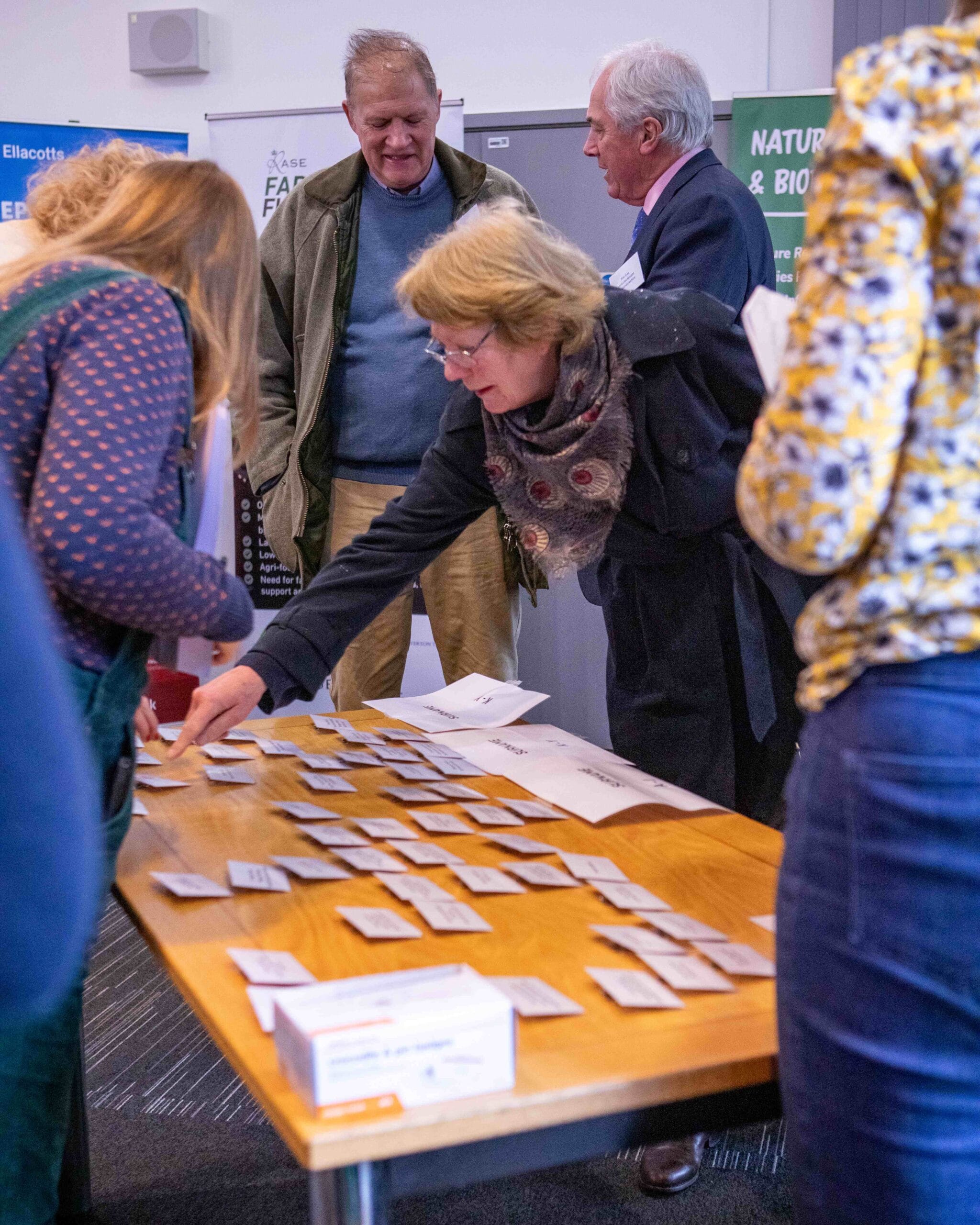People collecting name badges at event